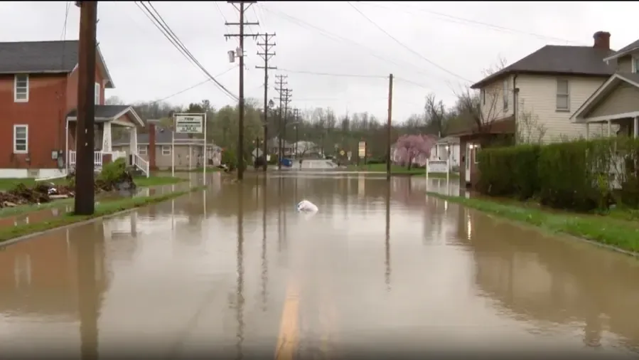Storm water flooding a street and front yards after a heavy summer downpour