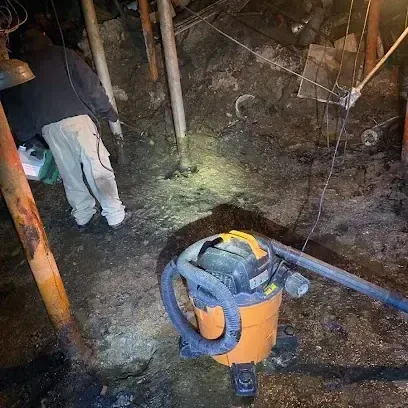 Technician pulling standing water off a floor with an extraction wand